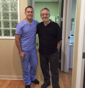 Dr. August de Oliveira with a male patient