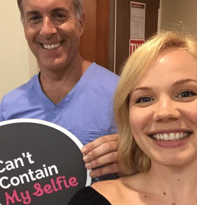Man holding can't contain my selfie sign