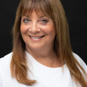 Smiling woman in white shirt