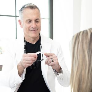 Man holding a denture